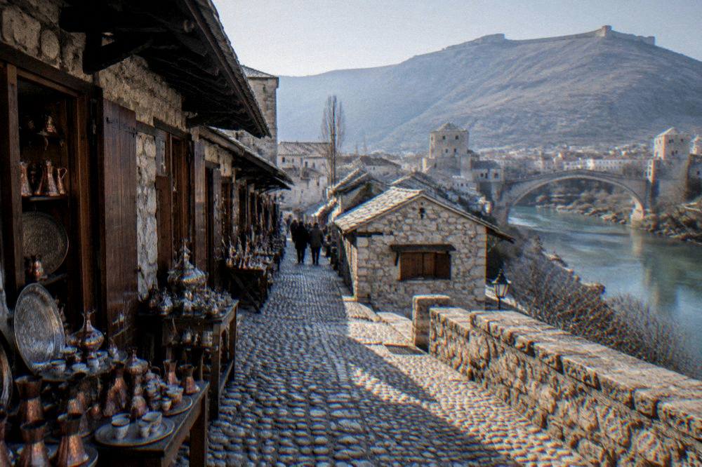 A fortified stone village on a hillside above a wide river bend