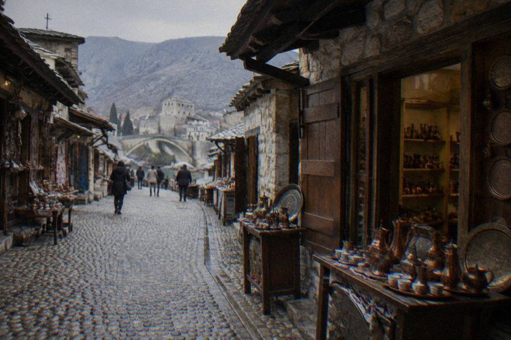 A narrow cobbled bazaar street in Mostar lined with small stone shops under overhanging roofs